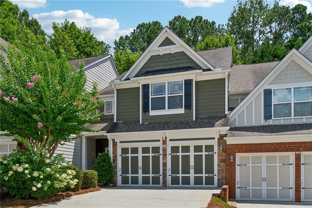 Welcome home to easy living in the highly sought-after Parc @ Wiley Bridge community—ideally located between the charm of Downtown Woodstock and the convenience of Roswell. This well-kept townhome offers a functional layout, thoughtful features, and low-maintenance living in one of the area’s most desirable neighborhoods. Step inside to a welcoming main level with an open-concept design. The kitchen offers ample cabinet and counter space, perfect for everyday cooking and casual entertaining. The adjoining family room features plush carpeting and great natural light, creating a cozy and comfortable space for relaxing or gathering with friends. Upstairs, the spacious owner’s suite includes double entry doors and not one—but two—separate walk-in closets, complete with custom built-in cabinetry for exceptional storage and organization. The ensuite bath features a double vanity, soaking tub, and separate shower for everyday convenience. Additional highlights include a professionally epoxy-coated garage floor, providing a clean and durable finish, and a newer HVAC system installed just about two years ago. The roof was recently replaced by the HOA, giving peace of mind and long-term value. Outside, enjoy your own private courtyard—perfect for morning coffee or winding down in the evening. The community offers a peaceful setting with easy access to shopping, dining, parks, and top-rated schools. With a smart layout, updated systems, and a location that can't be beat, this townhome is a fantastic opportunity to enjoy comfort and convenience in style.