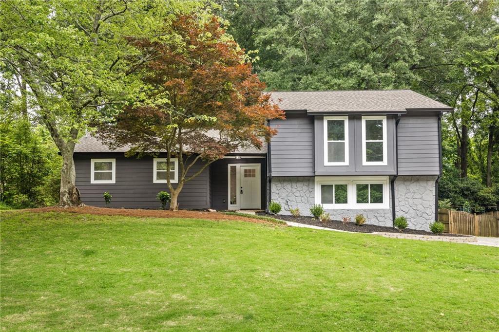Experience your own private oasis in this newly renovated Decatur gem located on a quiet cul-de-sac street. This home offers the perfect mix of an open concept floor plan with two additional separate living areas. The thoughtfully designed kitchen features sleek quartz counters, stainless appliances, tile backsplash, tons of storage, and a large island with breakfast bar. Kitchen opens to the dining room and fireside family room. Retreat to the incredibly spacious vaulted cedar planked sunroom overlooking the private backyard. With its wood-burning stove and seemingly endless walls of windows, this bright and airy sanctuary brings the outside in and is the perfect place to unwind. Upstairs there are 3 bedrooms and 2 full bathrooms, including the primary suite with soaking tub, separate shower, double vanity, and walk-in closet. The large walk-out terrace level has an additional bedroom, 1 full bathroom, a living area with kitchenette, and its own private entrance. The large deck overlooks the wooded backyard with fire pit. Brand new roof, HVAC, water heater, appliances, flooring, siding, almost everything! Just minutes to Oak Grove Market, restaurants, and coffee shops. Enjoy the great outdoors at the 21-acre Briarlake Forest Park with walking trails, pavilion, and bird sanctuary. Or head to Pea Ridge Park featuring playground and picnic areas, both easily accessible from your new home. Convenient to I-285, Hwy 78, the VA, CDC, and Emory.