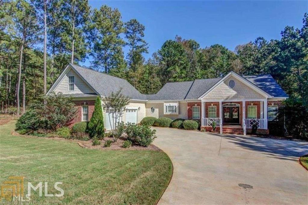 Beautiful Beautiful home with elegant columns throughout. The double doors open to hardwood flooring, open and inviting dining room and family room with fireplace and built in bookcases with entertainment center. The kitchen is awesome with island/bar area. Lots of solid wood cabinets with solid surface tops. The kitchen opens to the breakfast area and keeping room, these rooms are open to family room with double French doors and opens to the side deck. Split bedroom plan, spacious master with large bathroom and walk in closet with shelving system. Area off kitchen has built in desk, laundry room, pantry, LARGE Bonus Room upstairs. Home is equipped with security system, ring doorbell, custom drapery in some areas, ceiling speakers and recess lighting. Not in a subdivision and you have a private backyard! Lawn Care Included.