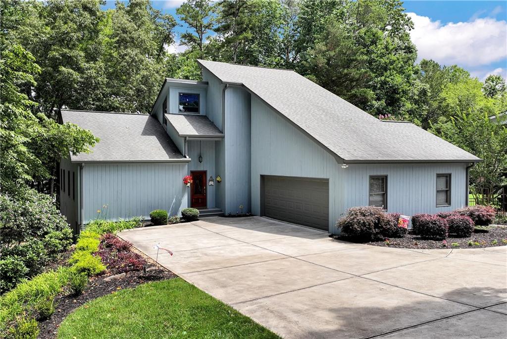 Tucked away on a quiet street in Dawsonville, this Lake Lanier home offers a hard-to-find mix of privacy, space, and direct lake access—complete with a private double-slip dock with a party deck. Set on .37 acres, the home features an open layout filled with natural light. The fireside family room flows into the dining area and kitchen, with large windows framing peaceful lake views. Off the main living area, enjoy both a screened-in porch and an open deck overlooking the water—perfect for relaxing or entertaining. The primary suite on the main level offers vaulted ceilings, a walk-in closet, and a private bath, with an adjacent flex room ideal for a home office or sitting area. Upstairs, you’ll find two additional bedrooms, a full bath, and a spacious attic for extra storage. The finished lower level includes a second family room, another bedroom and bath, and walk-out access to the gently sloped backyard and wooded path to the lake. Ample storage is available throughout the home, including multiple closets and a workshop area on the lower level for lake gear or hobbies. Whether you’re looking for a full-time residence, a weekend getaway, or an investment property, this Lake Lanier retreat combines comfort, convenience, and direct access to the water. Two additional adjoining parcels are also available for a combined .87 acres.