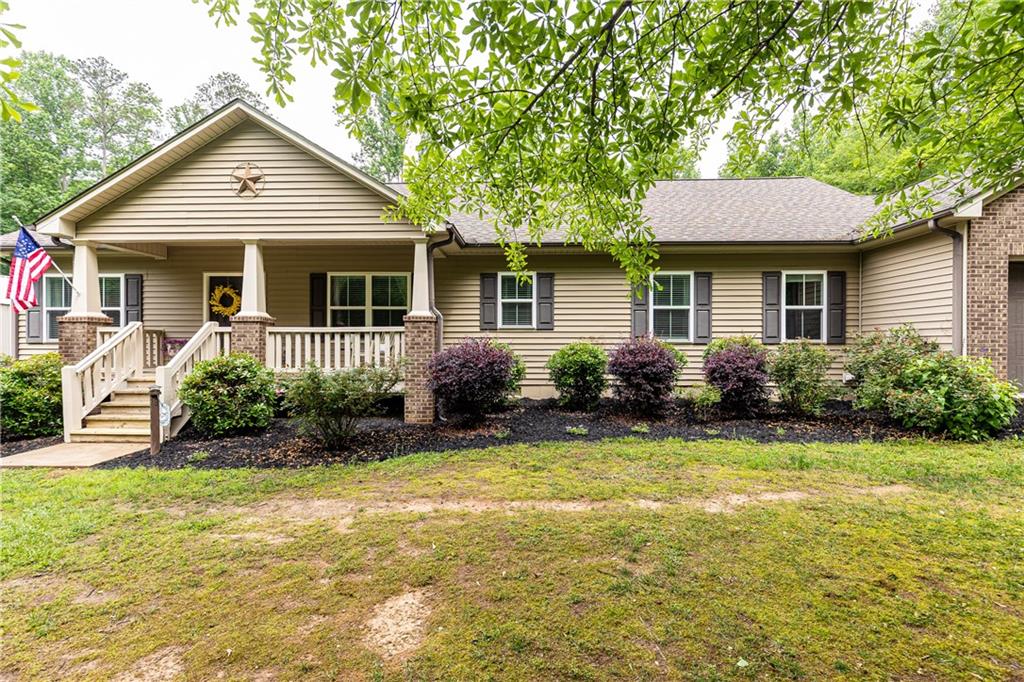 Meet this charming turn-key ranch style home with stylish modern farmhouse finishes featuring nearly 5 acres of land. Ideally for a private estate, equestrian setup, small farm or investment opportunity. Potential for new construction as well. A spacious 1,500 sf shop/outbuilding adds versatility for hobbies and storage galore. Inside, you'll find an updated kitchen and bathrooms, an open-concept layout, beautiful hardwood floors and generously sized bedrooms. the renovated primary bath adds a touch of luxyry, while the serene covered patio creates a wonderful outfdoor living space perfect for relaxing or entertaining guests overlooking your private backyard and surrounding woodlands. Additional features include a 2-car garage plus an extra garage for added storage or workspace. Located near excellent schools and within close proximity to Downtown Cumming, shopping, dining, parks and local attractions. This property truly offers the best of peaceful cuntry livng with modern convenience!