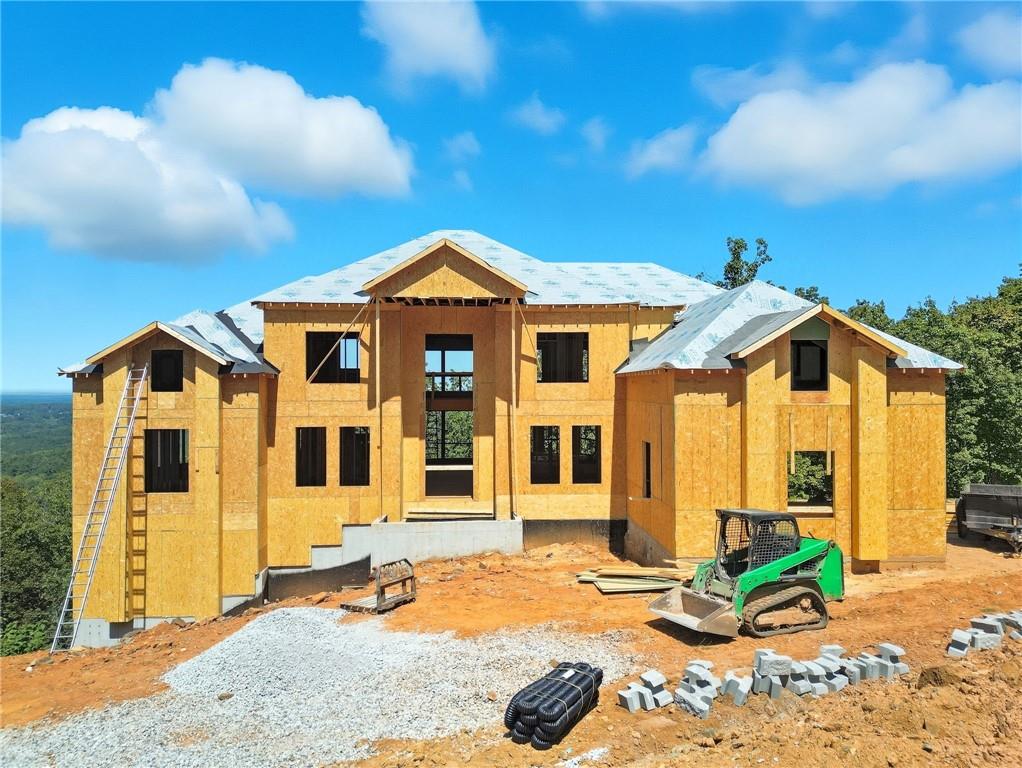 VIEWS.....ohhhh, the VIEWS!!!! Very UNIQUE opportunity. Absolutely breathtaking LONG-RANGE VIEWS are enjoyed from one of the highest points in the whole of Cobb County! Imagine if you will, MOUNTAINSIDE LIVING in the heart of West Cobb. Why go to the north Georgia mountains when you can enjoy having a vacation every single day in your home? The GRAND entrance of this home is simply the teaser for the delights that await you inside. As you enter the home, rich, warm HARDWOOD floors grace the main floor. IMPRESSIVE entry is two-story and light-filled as it welcomes you into your safe place. TOP-OF-THE-LINE appliances decorate the kitchen that would be coveted by any chef! Gorgeously appointed with a sleek trim package you would expect. OWNER'S SUITE on the MAIN FLOOR is a true retreat to escape everyday life coupled with a to-die-for primary bath with a stand-alone tub, large shower, exceptional vanity space. The CLOSET for the Owner's Suite is extraordinarily SPACIOUS and a sight to behold. Also on the first floor you can find your Laundry Room, OFFICE/STUDY/LIBRARY, great room with VIEWS and access to your PRIVATE, oversized deck. As you walk up the GRAND STAIRCASE, the overlook allows you to peruse the beauty of your home from open walkway. The FOUR Secondary BEDROOMS are generous with spacious closets. ENORMOUS BONUS ROOM to be imagined as you please to suit your lifestyle. 3-CAR GARAGE allows for storage of your vehicles and functional drive allows for more guest parking. The TERRACE LEVEL boasts 2 levels of additional living space to make your own. Imagine your theater room, a kitchenette, additional bedrooms and bath. The exterior porch can have a built-in hot tub if desired. It's all awaiting your touches to make it exactly what fits into your lifestyle. Home can be prepared for elevator (Optional upgrade.) All semi-custom at this point with allowances granted to make your own choices. Hurry so you can make this home uniquely YOURS. When the sun sets on the horizon and these coveted views belong to you, you will know you are HOME! ALL INFORMATION, INCLUDING SQUARE FOOTAGE IS APPROXIMATE AND SUBJECT TO CHANGE based on building needs and governing authority requirements. PLEASE do NOT walk site without permission and being accompanied by a team member since this is an active construction site!!! Site may be viewed clearly from the street.
