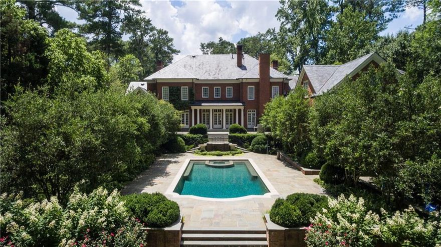 Elegant traditional home in the prestigious Tuxedo Park area of Buckhead. Designed by Duane Stone, this home is exceptional in quality and detail. Ceilings on main are 11' with 13' in the living room. Walk out back yard w/beautiful pool and large flat yard. Elevator, master suite on main w/adjoining library, 4 large bedroom suites upstairs w/living room, suite above three car garage, huge terrace level w/exercise, media, workroom, office/bedroom w/full bath.  Lg kitchen open to family rm. Fabulous home for entertaining - owners have hosted many large charity events.