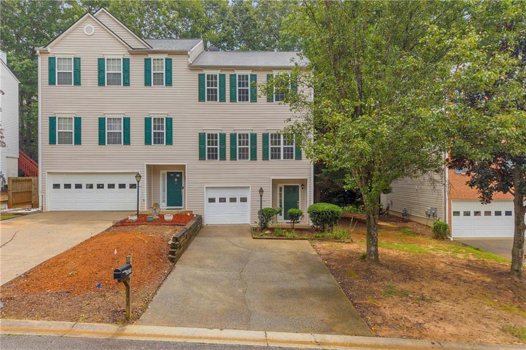 Beautiful end-unit nestled in the sought after Baker Heights neighborhood! Home has been meticulously maintained and upgrades include new paint and flooring, brand new stainless steel appliances, quartz countertops in upstairs bathrooms, and all new lighting throughout. The main level offers a light-filled family room with fireplace, an eat-in kitchen with island, a half bath, and a deck that’s the perfect spot to relax as you overlook your private backyard. Upstairs primary suite is a great spot to unwind and includes not one but two primary closets with a double vanity! Secondary bedroom also has it's own private bathroom with his/her closets and updated plumbing fixtures. The attached garage on the lower level includes an unfinished area that is perfect for extra storage or a workshop. Enjoy the convenience of hassle-free living as the HOA covers all front yard maintenance. Conveniently located by I-75, downtown Acworth, Kennesaw Mountain, and plenty of restaurants and shopping. This townhouse is not just a place to live, but the perfect spot for those seeking comfort and convenience in a delightful community.