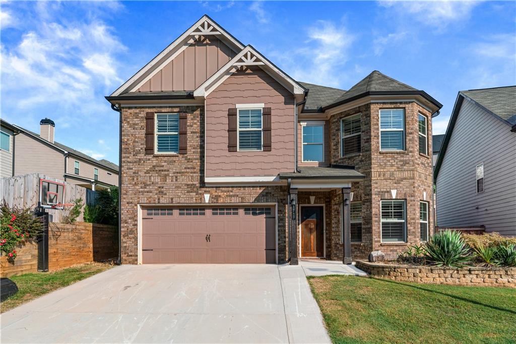 Welcome to this meticulously maintained 5-Bedroom home in Highly Sought-After Community, nestled in one of the area's most desirable neighborhood! This beautiful home is in a swim and tennis community with sidewalks throughout. It is conveniently located right around the corner from Mall of Georgia and near anything you could possibly ask for. From the moment you step into the house, you'll appreciate the care and designer updates that make this property truly move-in ready. Gleaming hardwood floors throughout the ENTIRE Home, complemented by fresh, neutral paint. Luxurious 100% Wood Plantation shutters throughout the entire home provide privacy, and updated light fixtures add a modern touch. The spacious layout offers both comfort and function, with ample room for living, entertaining, and everyday life. Stunning gourmet kitchen with oversized island, walk-in pantry, ample counter and cabinet space with beautiful granite countertops. Beautiful open living room with incredible views into the private backyard! Outside, you'll find a fenced backyard, a stone flower bed in the front, and a stone retaining wall in the back. Relax on the covered back porch and enjoy all this lovely home has to offer!