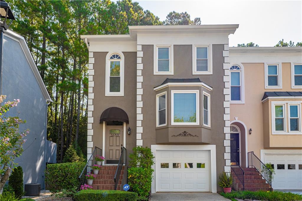 Welcome to this spacious and beautifully updated three-story end-unit townhome in the heart of Duluth! Featuring 3 bedrooms, 3.5 bathrooms, and modern finishes throughout, this rare gem offers an ideal layout for both comfortable living and effortless entertaining. Step into the bright, open main level, complete with gleaming hardwood floors, a renovated kitchen, and a spacious separate dining room. Fresh, neutral paint gives the entire home a clean, move-in-ready feel. From the cozy main-level family room, walk out to your private deck overlooking a beautifully landscaped courtyard—a truly unique feature that sets this unit apart. Upstairs, you’ll find a generous primary suite with double vanities, a separate shower and soaking tub, and a walk-in closet. Spacious guest bedroom with ensuite full bath and walk in closet. The versatile lower level includes laundry closet, garage access and a large bonus room—perfect for a home office, recreation area, or guest suite, full bathroom and large walk in closet with ample storage space. From here, step out onto the private back patio and enjoy access to a serene, park-like backyard—ideal for relaxing or entertaining. Additional highlights include: Newer Roof & Gutters, New HVAC, Water Heater & Windows, New Garage Door & Front Door. Located in a highly sought-after Duluth community, this home offers easy access to shopping, dining, and major highways. Don’t miss this rare opportunity to own a beautifully maintained end-unit townhome in a prime location!