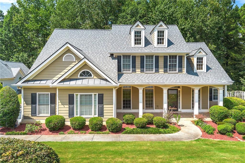 You’ll fall in love as soon as you drive into this beautiful neighborhood and up to this Southern Craftsman charmer, perfectly set on a cul-de-sac with a manicured lawn and side-entry garage!
Inside, the spacious dining room to your left is ideal for family gatherings and holiday meals. The oversized family room is the heart of the home—perfect for movie nights and game time. The open gourmet kitchen flows seamlessly into the sunroom, where you can start your mornings with coffee and natural light.
The first floor offers a luxurious main suite with a large sitting area that’s big enough for an office, a sofa, reading nook, or even an exercise space. Relax for hours in the spa-like bathroom with a soaking tub. An additional first-floor bedroom and full bath provide the perfect private space for guests.
Upstairs, you’ll find generous secondary bedrooms, each spacious enough for kids, guests, or even a home office.
Enjoy outdoor living on the covered rocking-chair front porch—deep enough for a swing and plenty of chairs. This home offers space, comfort, and charm in every corner.
Don’t wait—this one won’t last!