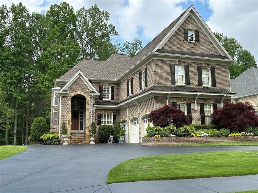Welcome to this stunning custom home that fuses luxury, elegance and functionality. Located
one-minute away from Marietta Country Club and Mount Paran Christian School, this European-
style estate features a beautifully landscaped front yard, a circular driveway, a four-sided
stone/brick exterior, a 3-car garage, and a picturesque backyard with much privacy.
Step inside, you will find spacious rooms with 10-foot ceilings on the main floor, 9-foot ceilings
on both the second floor and the basement, as well as hardwood floors throughout the house.
This impeccably maintained interior is further accented by exquisite molding details and
painstaking craftsmanship. The back of the house is entirely covered by large picture windows
looking out to the expansive woods outside. The main floor offers a large space with living and
dining areas, a family room opens to the chef's kitchen, a cozy breakfast area with natural light
from the bay window, a sunroom leading to the rear deck, and a kitchen featuring a custom range
hood, 6-burner gas cooktop, stainless steel appliances (including a double oven, a refrigerator,
and a dishwasher), a walk-in pantry, granite countertops, and tile backsplashes. Upstairs, the
large primary ensuite boosts a sizable bedroom, a sitting area, a luxurious bathroom with a
frameless glass shower and a jetted tub, and a walk-in closet full of custom shelves. The second
floor also contains three additional bedrooms and two bathrooms, including a Jack and Jill bath
with individual sinks. Walk downstairs, the fully finished basement offers space for
entertainment. This includes a 5th bedroom, a 4th bathroom, a luxurious bar, a media area
equipped with a presentation system, an area for a pool table, as well as two storage areas. Walk
out from the basement is a private patio.
Since purchasing, the owner of the house made numerous upgrades. These include, but are not
limited to, upgrading from the carpet to the hardwood floor on the second floor and the
basement, upgrading the screen porch to a sunroom, upgrading the wood railing to a wrought
iron railing for the stairs, and upgrading the landscape for both the front yard and the backyard.
In addition, the stove and stove vent hood, the refrigerator, the dishwasher, the air conditioner
(with 5-year warranty), and the house roof are all installed in recent years, and the interior walls
of the entire house are newly painted.