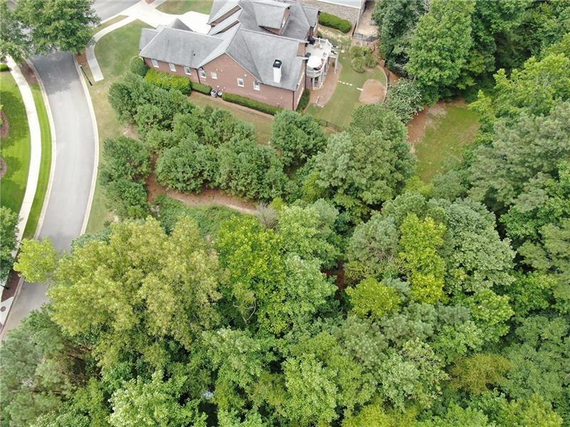 Nestled between two peaceful cul-de-sacs in a prestigious high-end golf club community just outside Atlanta, this nearly half-acre lot offers the perfect canvas for your dream home. The property boasts a serene and private setting, enhanced by a natural wooded barrier on two sides, providing both beauty and seclusion. Located on a quiet street with minimal traffic, this spacious lot combines tranquility with access to upscale amenities, making it an exceptional opportunity for refined living. This is an ideal lot for a walk out basement. Enjoy the best of Cobb County at your fingertips.