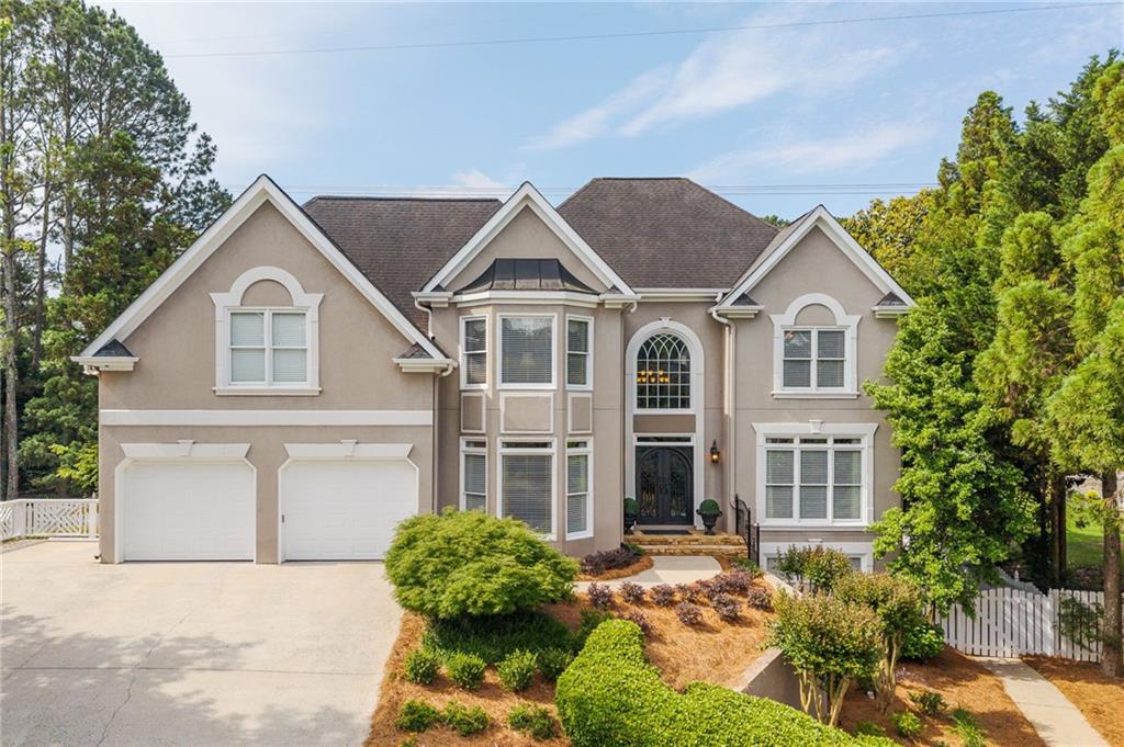 Welcome to timeless elegance in Sewell Farm. A swim/tennis neighborhood located in the
heart of East Cobb. This stunning home in the sought-after Walton High School district
boasts exceptional finishes throughout. From its Grand Foyer with detailed moldings,
hardwood floors and decorative iron staircases. Two story great room has built-ins
surrounding the stone fireplace and is open to both eating area and dream kitchen which
make an ideal space for entertaining. The floor to ceiling windows overlooks a large, level,
useable, meticulously maintained fully fenced backyard, including a pool with waterfall
feature and sports court. Plenty of space to include a playground, trampoline, or both.
Bedroom with full bath on the main level; upstairs includes a huge primary suite with trey
ceilings, custom closet, and spa inspired bathroom. Heated floors, slipper tub, and
separate walk-in glass shower. Three additional bedrooms, adjoin bathroom, and guest
room with private bath complete the upstairs. Amazing space in the basement with acid-
stained floors, 400 square foot gym with mirrored wall. Kitchenette area, additional
bedrooms, full bath, and office/flex space. Ample storage. Separate entrance ideal for
home business or multi-generational living. Central vac, intercom/sound system
throughout, concrete curbing both front and back. Architectural shingles, tankless water
heater, and guardian garage floor. Convenient to Marietta, The battery, and Roswell. Easy
a c c e s s to I-400 and I-285. Walking distance to Dodgen and Walton. Low Cobb Taxes.
Truly a Must See.