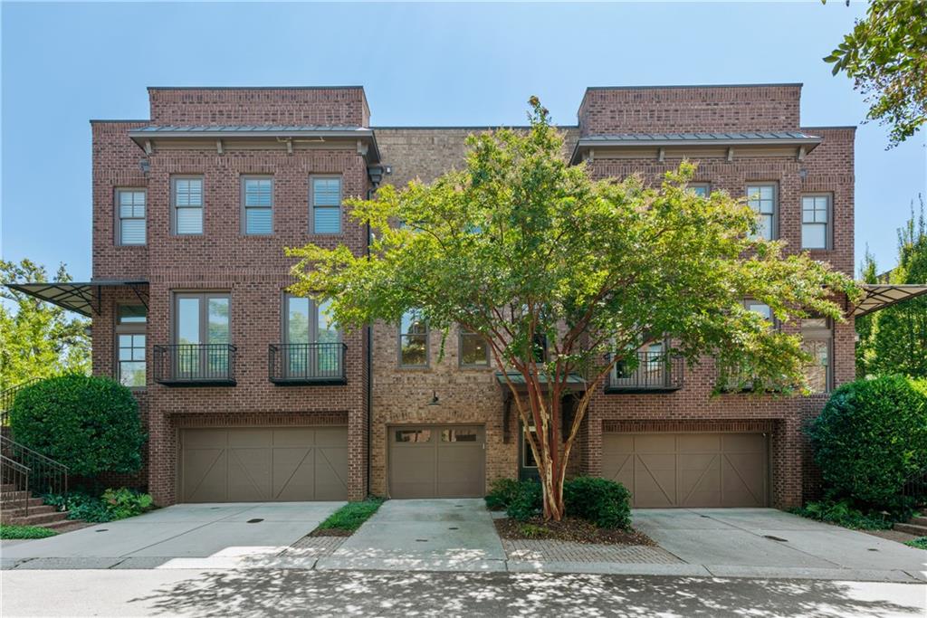 Walkable lifestyle in the heart of downtown Historic Roswell! Gorgeous brownstone just steps off Canton Street in gated Providence. Move-in ready with fresh paint, durable flooring and an easy-living layout. Main level features an open floor plan that allows light fill the entire space. Family room is divided from the dining space by a two-sided fireplace. Kitchen features a center island, gas range, new backsplash, granite counters, a pantry, and plenty of cabinet storage. Kitchen is open to the dining space and to the rear open-air deck, an ideal outdoor sitting space or a place for an herb garden. Upstairs you'll find a spacious primary suite with large, bright windows, a huge walk-in closet, an additional walk-in closet and a large bath with double vanity, soaking tub and walk-in shower. The second bedroom is also suite style with a walk-in closet, and bathroom with a tub, shower and a vanity with plenty of storage space. Laundry room and linen closet is nicely situated between the bedrooms for convenience. The lowest level features an oversized space with a built-in ventless fireplace that could be used as a bedroom, a theater room or a home gym. Large door and windows give a view to the private courtyard space that provides both covered space for sitting and sunny space for a garden. Full bath and space for a walk-up bar complete the lower level. One-car garage provides secure parking with additional parking available in the driveway and designated parking spaces within the gated complex. The community provides you an outdoor pavilion with a stone fireplace, a dog park, and the feeling of being tucked away in a secret corner. While you will love this home, you will truly love the walkable access and lifestyle you'll gain living here. Literal steps from Canton Street means you can join the party when you want, and walk home to peace in minutes. You will love exploring the restaurants and shops. You will love the walkable lifestyle, only a short ways to the River and Riverwalk or to the Roswell Area Park. You will love your neighbors who are friendly, welcoming and who appreciate how lucky they are to live this life. You will truly love living here. These homes are rarely on the market - don't miss your chance, book your showing today.