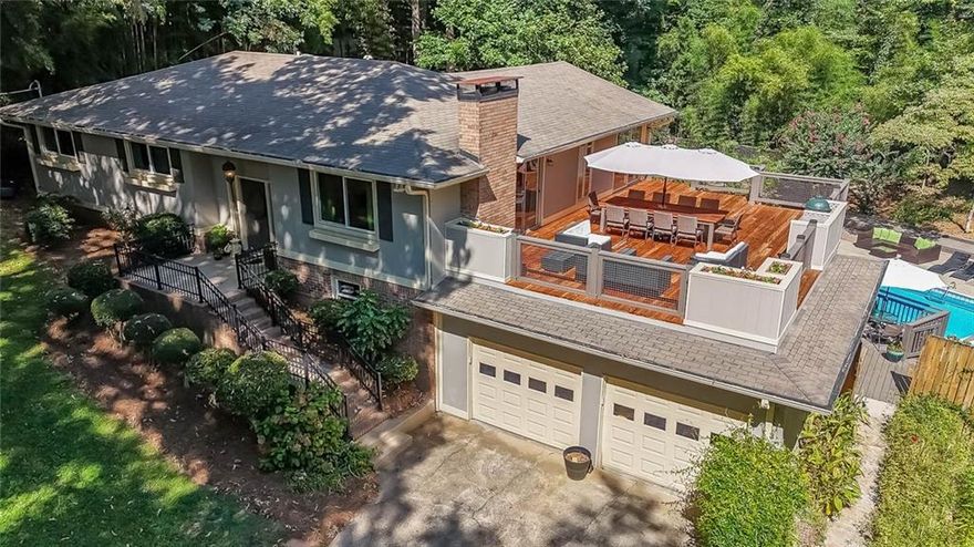 This one is the perfect combination of warm and charming indoor space and amazing outdoor living. The lot has wonderful privacy with a natural side yard with mature trees and plantings and a garden of wildflowers leading to the backyard where the inground pool sits surrounded by beautiful landscaping and a beautiful pergola. The decking that surrounds the pool includes a covered deck with a cozy sitting area, open deck area for grilling, a more secluded area with a hot tub and sitting area, and then the most amazing rooftop deck overlooking the property you could imagine complete with planting boxes and built in smoker station. The interior of the home is so charming with multiple common areas including a fireside family room with built in bookcases and a sunroom. There are 3 bedrooms on the main level and a basement with a newly finished full kitchen, an office that could be utilized as a 4th bedroom,  and a full bathroom. No carpet anywhere and tons of natural light flowing in. Outbuilding on property for storage. Wonderful community with no HOA and a picturesque lake across the street from the property. Great schools and access to all highways. This property is more than a house, it is truly a retreat!