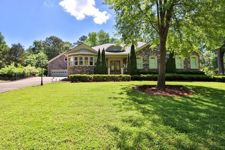 Welcome to this gorgeous one-of-a-kind sprawling ranch home built on a full basement. Completely custom built in 2007, this 4-sided stone masterpiece has been meticulously maintained through the years. Featuring an extensive amount of finished space on the terrace level, and a separate detached 3-story 3-car garage with ample storage space… you won’t find another property like this! Recent big-ticket updates include: BRAND NEW ROOF (2023) and TWO BRAND NEW 40-gal WATER HEATERS (2024) w/ NEW RECIRCULATING PUMP. Upon entry, you're greeted with a grand entrance showcasing tons of space and natural light flowing into the home. The entire main level features gorgeous hardwood floors, 3 bedrooms and 2.5 bathrooms. The heart of the home lies in the kitchen, which features custom cabinetry with gorgeous glass fronts, Corian countertops, a double oven, and butlers pantry! With ample storage and prep space, this kitchen is as functional as it is beautiful. The master bedroom features an expansive layout with a separate sitting area, plus his/her closets (one of which is a full cedar closet!). The ensuite bathroom is fully handicap accessible with a huge walk-in shower, claw foot tub, double vanities, and plenty of storage space. The terrace level basement is finished and full of windows! Built-in bookcases decorate most of the walls, suitable for thousands of books! Additionally, 2 additional bedrooms on this lower level share a full bathroom. With a 2nd living room space, plus an additional fireplace, office, and workshop/sewing room – the numerous versatile spaces can be tailored to suit your unique needs. About 400sqft of unfinished space is equipped with plenty of built in storage shelves. Outside, your private backyard features a deck crafted from durable Trek decking plus a fenced-in covered porch area perfect for pets or children. The detached 3-car garage is oversized with ample room for large vehicles, all your motorcycles & toys, etc. The upper level of the garage is an unfinished attic space and the lower level is a single stall garage perfect for a workshop or to store all your lawn mowers, tools, etc. SEPTIC PUMPED 2022. Conveniently located in East Cobb near Roswell Rd with quick access to plenty of shopping, dining, and interstates. Welcome Home!