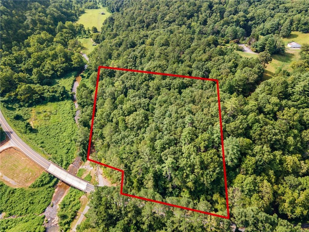 Build your dream home or mountain getaway on this beautiful 3.11-acre property located just minutes from downtown Jasper. This tract offers a perfect mix of privacy and accessibility, with a completed septic perc test, an old driveway already in place, and a semi-cleared building site ready for your vision. The land features gently rolling terrain with mature hardwoods and is situated directly across the street from a scenic creek.Enjoy the tranquility of the North Georgia foothills while still being close to shopping, dining, and schools, with easy access to GA-515 for commuting to Canton, Ellijay, or Atlanta. With utilities nearby, a head start on site prep, and nature all around, this property is ready for your next chapter in Pickens County.