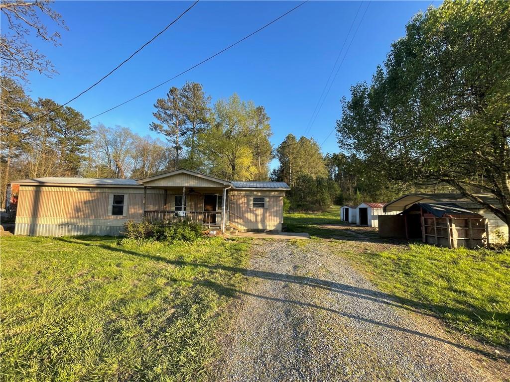 14x60 mobile home sitting on 0.96 acres. Mobile home needs TLC, was recently rented out for $500/month from 2017-2022. Large lot with over 220' of road frontage, land lot also has 2nd driveway entrance where additional mobile home could be placed? Property is located directly across from Allens Market/gas station and less than a mile from RedBud Schools. Home sold as-is and all portable buildings on property will stay also.