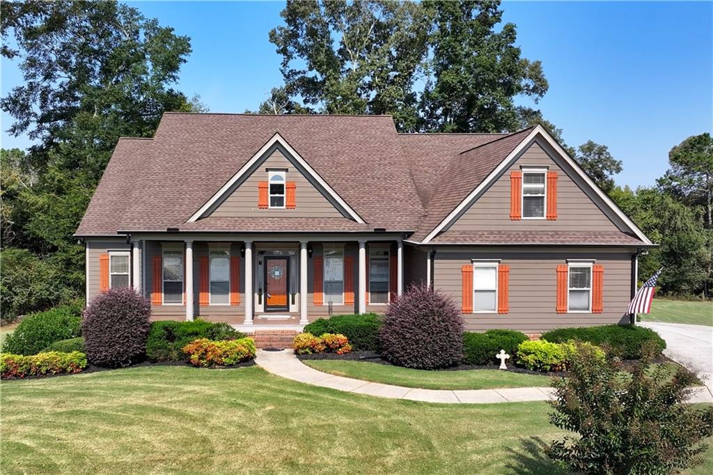 Beautiful home on 1.5 acres in the desirable Whitaker Downs neighborhood! This 5 bedroom, 5.5 bath property welcomes you with a southern front porch, hardwood floors, and designer details throughout. The bright living room with brick fireplace opens to an updated kitchen with Corian countertops, tile backsplash, and an island with a second sink, along with a vaulted formal dining room. The main-level Owner’s Suite offers a spa-like bath, large walk-in closet, and private sunroom access, while two additional bedrooms complete the main floor with a full bathroom in the middle; upstairs you’ll find a private bedroom suite with its own full bathroom plus a versatile flex room, and the finished terrace level is perfect for guests or multi-generational living with its own private driveway, 1-car garage, full kitchen, storage, large living area, bedroom suite, and two full bathrooms. Extras include sunroom, tankless water heater, NEW basement HVAC, composite decking, and more—all just minutes from the new Heros Elementary and Legacy Knoll Middle schools.