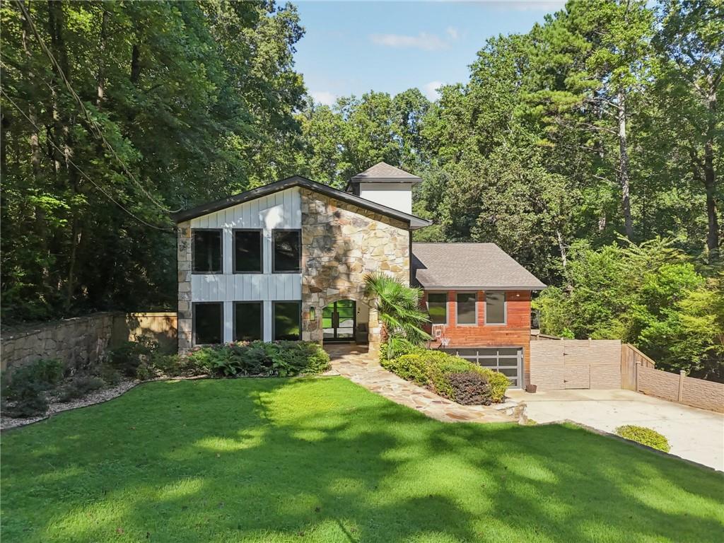 CUSTOM CONTEMPORARY DESIGN | HEATED POOL & OUTDOOR KITCHEN | FINISHED TERRACE LEVEL | MAIN-LEVEL OWNER'S SUITE | MINUTES TO THE BATTERY & TRUIST PARK | EAST COBB LUXURY
Welcome to 1464 Pebble Creek Road SE, where modern sophistication meets resort-style living in the heart of East Cobb’s premier luxury corridor. This stunning 5-bedroom, 5.5-bath custom estate offers nearly 6,000 square feet of art deco-inspired design, curated with high-end finishes and thoughtful details that elevate everyday living and make entertaining effortless.
Step inside to an expansive open-concept layout where floor-to-ceiling windows, rich textures, and designer lighting set the tone. The gourmet kitchen is a showpiece, featuring striking stone countertops, sleek cabinetry, and gold-accented high-end appliances, perfect for culinary creations or hosting in style.
The main-level owner’s suite is a private sanctuary, boasting a custom walk-in shower, luxurious finishes, and direct access to a private balcony overlooking your backyard oasis. Upstairs and on the terrace level, every room is designed to maximize space, comfort, and natural light.
The fully finished terrace level is an entertainer's dream, complete with a wet bar, wine cellar, game room, and a private home theater—ideal for unforgettable movie nights or weekend gatherings.
Outside, indulge in your own resort-style retreat featuring a heated in-ground pool, modern cabana setting, and outdoor kitchen—perfect for al fresco dining, summer celebrations, and quiet mornings by the water. This one-of-a-kind estate is not just a home—it’s a lifestyle. Enjoy the perfect combination of luxury, location, and custom craftsmanship in one of Cobb County’s most coveted communities. Schedule your private showing today and experience an elevated style of living.