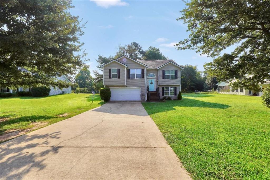Don't miss this 5-bedroom, 3-bath split-level home nestled on a quiet street with a fully fenced backyard-perfect for outdoor living! The main level features a large living room with cozy fireplace, separate dining area open to the living space, and a galley-style kitchen with a sunny eat-in nook. The spacious primary suite offers vaulted ceilings, a large walk-in closet, and a private bath with dual vanities, garden tub, and separate shower. Two additional bedrooms and a full bath complete the main floor. The fully finished lower level includes two more bedrooms, a full bath, and a flex room-ideal for a home office, playroom, or gym. A large 2-car garage offers plenty of storage. This home has space for everyone, inside and out. Schedule your showing today!