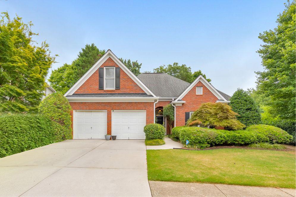 Here it is! The perfect home your family has been looking for! Welcome to this meticulously maintained 4 bed / 3.5 bath ranch home, perfectly situated in the sought-after St. Charles Square swim/tennis community in East Cobb. Step inside to an inviting foyer that opens to a fireside living room with vaulted ceilings and a built-in entertainment center with bookshelves. The elegant kitchen features granite countertops, a JennAir gas cooktop, breakfast bar, and a sunny dining area. The spacious primary suite showcases tray ceilings, his-and-hers closets, and a beautifully updated bathroom with dual vanities, a luxurious shower, and a bench seating area. Two additional bedrooms on the main level share a lovely bathroom. Upstairs, a private bedroom with a full bath and walk-in closet offers the perfect space for guests, a home office, or bonus room. Additional highlights include plantation shutters throughout, newer LVP flooring, and a Generac whole-house generator. Enjoy a private, fenced backyard with a patio and serene water feature. This home is perfectly situated across from the community pond and nature trail, and also has access to the neighborhood pool, tennis courts, and playgrounds. Don’t miss your opportunity to make this delightful home yours!