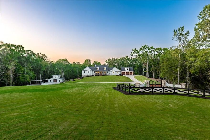 Welcome to 1017 Avery Road, a custom-built almost new-construction estate that redefines the idea of an executive countryside retreat. Set on 7.35 private acres in the coveted Creekview High School district, this home blends modern luxury with timeless rustic elegance, offering the ultimate escape while remaining close to top-rated schools, downtown Canton, upscale shopping and restaurants and convenient highway access (5 miles to 575).

Once through the gated entrance, the property unfolds with a mix of wooded trails, open pastures, and a peaceful stream meandering through the land. Zoned agricultural with no HOA, it provides a rare level of freedom and versatility. Two fully fenced pastures and a two-story barn offer endless possibilities, from horses and hobby farming to storage for vehicles, boats, or equipment or could be easily transformed into a "party barn" or workshop. This is more than a home—it’s a lifestyle.

Inside, soaring ceilings, expansive windows, and warm textures set the stage for a thoughtfully designed floor plan with four bedrooms, three full baths, and two half baths. The gourmet kitchen is the heart of the home, featuring striking White Patagonia quartzite countertops and backsplash, Wolf appliances, a Sub-Zero refrigerator, and custom cabinetry. The primary suite is a true retreat with vaulted ceilings, exposed beams, stone fireplace and a brick accent wall, while the spa-inspired bath indulges with herringbone-honed marble flooring, an oversized dual shower, and level four quartz countertops.

Every detail has been curated for both comfort and sophistication. The home includes an executive office, a custom theater with state-of-the-art sound, and a Sonos audio system with wired speakers throughout, including the vaulted screen porch. Outdoor living is equally impressive with a covered porch and stone fireplace, a separate grilling deck, and sweeping views of greenery and pastures.

Additional spaces elevate the lifestyle even further. The newly constructed barn is ready to adapt as a future pool house, workshop, or party barn. A private finished space sits above the three-car garage with panoramic views of the estate - currently being utilized as a home gym. The lot is pool-ready, with a design already completed by GA Classic Pools, and the terrace level has been prepped with rough-ins for a bath, sauna, and steam room.

Practical touches complement the grandeur, including tankless water heaters for endless hot water, a 25-zone irrigation system for lush landscaping, and a grand monument entrance designed for custom gates with gas lanterns casting a timeless glow. Full unfinished basement is great for storage or finish off for more space. Plenty of room for a pool.

From sunrise coffee on the porch to evenings by the fire, 1017 Avery Road offers unmatched privacy, natural beauty, and lifestyle versatility—all just minutes from shopping, dining, and top schools (Avery ES, Creekland MS and Creekview HS).