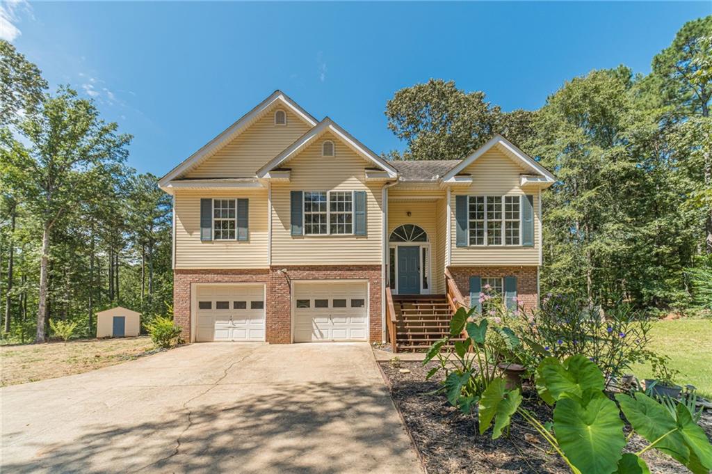 Just within walking distance to Social Circle Schools and downtown shops is this completely renovated and move-in ready, stunning 5-bedroom, 3-bath, 2-car garage home. The home offers both modern updates and family-friendly outdoor space. Inside, you'll find new flooring throughout, updated light fixtures, new door hardware, wide baseboards, and fresh granite countertops in the kitchen and bathrooms. The chef's kitchen features a deep farmhouse sink, new stainless steel appliances, and plenty of space for cooking and entertaining. The home is bright, clean, and thoughtfully updated, with a fireplace in the living room for cozy winter evenings. A storage room off the garage offers an ideal workshop or game room for kids. Outside, the property has been beautifully enhanced with trees removed to create a larger yard, new grass, and a turnaround driveway for convenience. Three sides of the yard are fenced, perfect for kids to play, pets to roam, or hosting family gatherings and barbecues. Enjoy the outdoors on the deck overlooking wildlife, or relax in the spacious, private yard. Set back from the road down a long, paved driveway, this home combines privacy, functionality, and charm ready for your family to move in and enjoy!