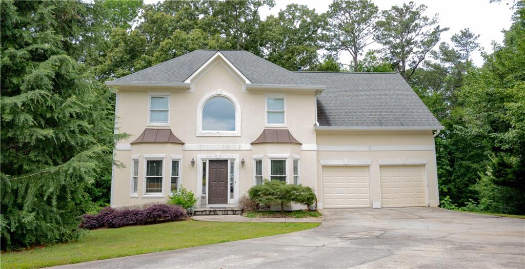 Experience the tranquility of lakeside living at this unique 4-bedroom, 2.5-bathroom home located in the heart of Cobb County. This home is situated on a private wooded lot in a quiet cul-de-sac, with direct walking access to Lake Acworth. Inside, you'll find a welcoming two-story entrance foyer leading to a formal living and dining room. A charming and bright open Kitchen with a breakfast nook overlooks the lake. The family room, with a gas fireplace and hardwood floors adds warmth and character to the home. The property also boasts a partially finished basement to create your own haven. Upstairs, the spacious owner's suite features a large sitting area, a bath with double vanities, a shower, and a separate garden tub. Three additional bedrooms and another full bath complete the upstairs living spaces. The laundry facilities are conveniently located on the upper floor for ease of access. Outside, you can enjoy the spectacular lake views from your private deck. Acworth effortlessly blends small-town charm with urban conveniences. Please note, there is no dock permit for the property.