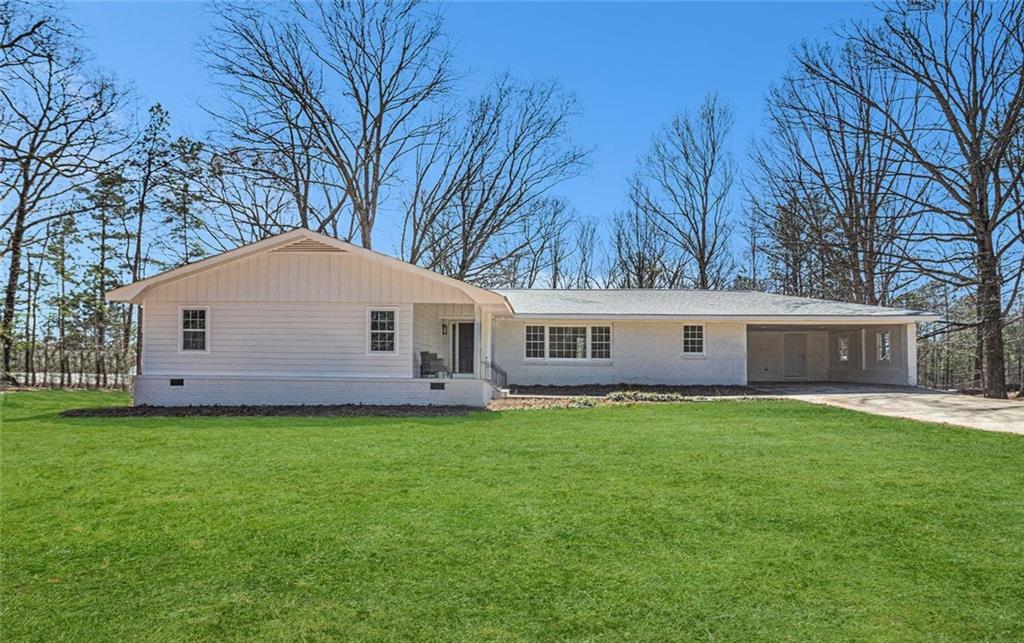 Welcome to 9640 Cedar Grove Rd in the heart of Chattahoochee Hills. This stunning 4-bedroom, 3-bathroom ranch home has been thoughtfully renovated, offering modern elegance and timeless charm on 2.6 private acres. With approx. 2,414 square feet of finished living space plus an additional approx. 1,830 square feet of unfinished basement, this home provides plenty of room to live, work, and grow. Step inside to an open-concept layout featuring luxury vinyl plank flooring, tile accents, and stylish finishes throughout. The kitchen boasts granite countertops, stainless steel appliances, a tile backsplash, and ample counter space. All four bedrooms are conveniently located on the main level, providing ease and comfort. This four-side brick home also includes a full unfinished basement, offering endless possibilities for additional living space or storage. Enjoy outdoor living with a spacious front porch, back deck, and covered patio, perfect for relaxing or entertaining. A 240-square-foot accessory dwelling unit (ADU) provides flexible space for guests, rental income, or a private office. Additional highlights include two fireplaces, a two-car garage, and a fenced backyard. Conveniently located near major highways, Serenbe, and all that Chattahoochee Hills has to offer, this home is a rare find blending modern updates with peaceful surroundings.