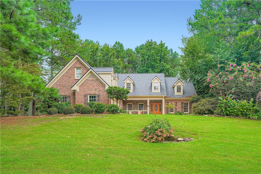 Excellent opportunity to acquire this charming 3-bedroom, 2-½ bath home with 9-foot ceilings filled with character and custom features, a newly remodeled kitchen, new AC, including two impressive stone ceiling-height fireplaces complemented by wooden beams and columns in the living room, family room, adjoining the kitchen, and dining room. The large master bedroom suite features a beautiful tray ceiling and a spacious walk-in closet with built-in shelves and ample storage space. Double doors open into the oversized master bathroom, which features double vanities, a jetted tub, and a separate shower. The spacious secondary bedrooms, located on the opposite end of the home, have generous closets and both
share a Jack & Jill bathroom. The laundry room also serves as a mud room leading in from the garage. Enjoy all the seasons with the enclosed sunroom. This home with great curb appeal is set back from the road on a large, picturesque, and private lot. The level, fenced, and wooded backyard also features a stone patio and sitting area for grilling with friends and family. There is a sweeping driveway with generous parking for several cars, including parking on the side of the home. The oversized double garage has a permanent staircase that leads to a floored attic with approximately 1500 sq. ft of storage space and/or space to convert to additional living areas. Newly renovated Kitchen, new HVAC systems, and an in-ground irrigation system. Located in the highly sought-after Hamptons Grant neighborhood in Alpharetta. Enjoy access to desirable community swim and tennis amenities. Easy access to GA400 and HWY 20, Downtown Milton, Downtown Alpharetta, Cumming, Roswell, top-rated schools, shopping, dining, and entertainment are just moments away. which provides a great school district and the advantage of Forsyth County taxes.