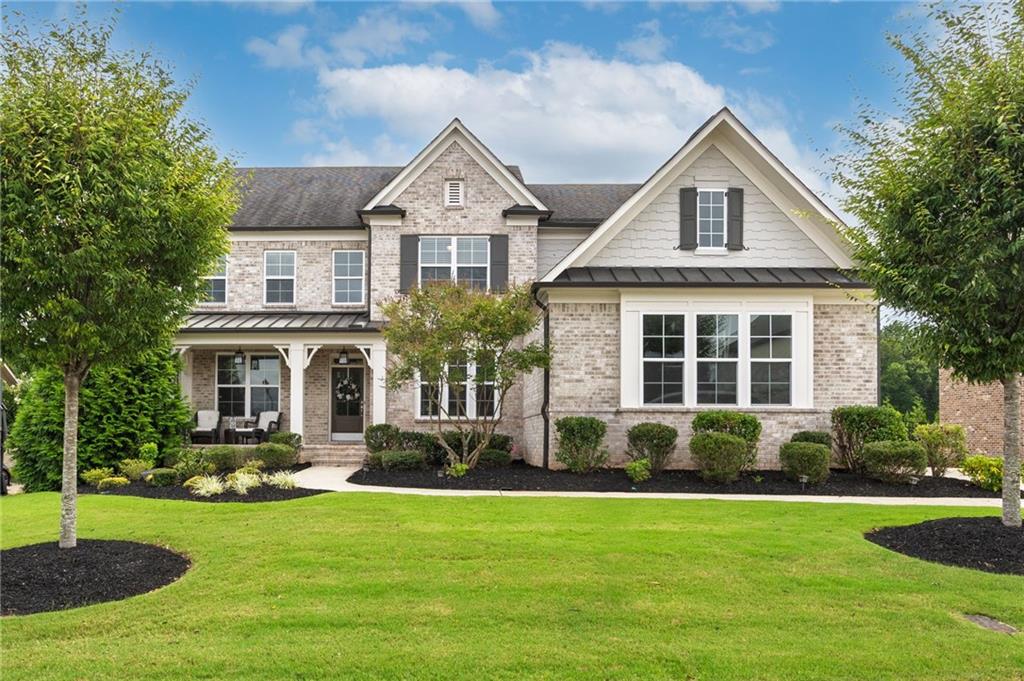 Amazing Opportunity in Woodstock Knoll! Excellent Model Home Condition! Absolutely Stunning Custom Home! Perfect Floorplan! Warm Rich Hardwood Flooring throughout! Large separate Dining Room! Stunning Great Room with 2-Story soaring ceiling that is breathtaking: Custom Coffered Ceiling and lighting! A Wonderful Custom Fireplace makes this the perfect gathering space! This Chef's Kitchen truly is the heart of the Home! Custom Cabinets, Quartz Countertops, Large Island, Breakfast Bar, Custom Brick Backsplash, Under-cabinet lighting, Walk-in Pantry, Top of the line Appliances include: Gas Range, Double Ovens, Microwave, Vent Hood, Dishwasher, and Double Wine Cooler! All this plus a Keeping Room space with Custom Fireplace! Bedroom and Full Bath on Main Level! Flex Space that could be an office/playroom/bonus room with French Doors completes this level! The most stunning primary spa suite features a huge bedroom with sitting area, luxury spa bath with soaking tub, large custom shower, lovely double vanities, custom tiled wall, huge closet and convenient laundry room off closet! This wonderful 5 bedroom 4 bath custom home offers a large 3 car main level garage and a daylight basement (stubbed for bath!). Wonderful undercover stone patio area and the most amazing landscaped yard you have ever seen! Start your morning on your private front porch and have dinner on your amazing Trex Deck and finish your day in your own private oasis complete with privacy fenced backyard, amazing landscaping, gorgeous huge stone patio, with a stunning stone fireplace --this is incredible! All this and minutes to downtown Woodstock Dining, Shopping, and Parks! The Best Location and Schools!