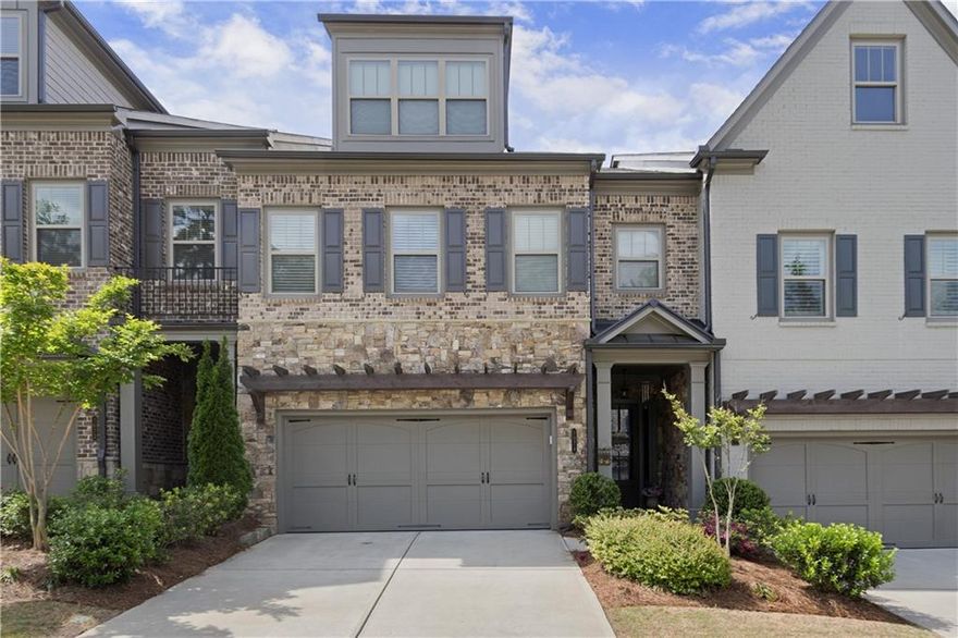Welcome to easy, low-maintenance living in the heart of Harlow East — one of Alpharetta’s most vibrant gated communities. This beautifully maintained three-story Concord Plan townhome offers the feel and space of a single-family home, with thoughtful upgrades throughout. Wide-plank hardwood floors flow across the open main level, where a gas fireplace, sun-filled living spaces, and a chef’s kitchen with stainless appliances, a built-in microwave, a walk-in pantry, and a butler’s pantry come together beautifully. Step outside to a fenced backyard, perfect for unwinding after a busy day or letting your pup out with ease.
One of the best features? A pre-installed elevator shaft gives you the option to easily add an elevator — allowing true main-level living without ever worrying about stairs. Park in the spacious two-car garage, bring groceries right inside, and enjoy the convenience of everyday life made simple.
Upstairs, the oversized primary suite offers a private sitting area, a spa-like bathroom with a freestanding soaking tub, oversized walk-in shower, double vanities, and a custom walk-in closet that connects directly to the laundry room with built-ins and a utility sink. Two additional bedrooms and a full bath complete the second floor. The top level features a massive open loft with a sleek wet bar, a fourth bedroom, and another full bathroom — perfect for guests, an office, or multi-generational living.
Life at Harlow East is more than just a beautiful home — it’s a lifestyle. Residents enjoy resort-style amenities including two swimming pools, tennis and pickleball courts, green spaces, scenic walking trails, two dog parks, a fire pit, and even a community vegetable garden. The spacious clubhouse features multiple gathering areas, a full kitchen, coffee bar, and large-screen TV, and is home to a packed calendar of events — from ladies’ nights and poker nights to food trucks, wine tastings, golf outings, and live music on the green. Walk to concerts at Ameris Bank Amphitheatre in under five minutes, and enjoy being minutes from Downtown Alpharetta, Avalon, Historic Roswell, Big Creek Greenway, and easy access to GA 400. Zoned for top-rated Manning Oaks Elementary, Northwestern Middle, and Milton High School, this home offers not just style and comfort — but true community.
Experience the best of Alpharetta living — where every detail is designed to make life easier, more connected, and a whole lot more fun. Schedule your private showing today!