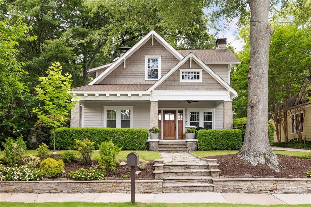 A rare opportunity to own a quintessential circa-1920 Craftsman, where historic charm meets thoughtful renovations. Set on a rare half-acre lot in the heart of Oakhurst, this home is rich with original details and modern updates. From the moment you step onto the expansive front porch, framed by striking granite columns, you’ll feel the timeless character of this home. Inside, soaring ceilings, seamless heart pine floors, and three fully restored masonry fireplaces create an inviting atmosphere filled with warmth. Craftsman charm abounds, with exquisite leaded glass built-ins flanking the living room fireplace, original two-panel wood doors with brass hardware, and a central dining room adorned with elegant wainscoting and plate molding. Throughout the home, meticulous craftsmanship and historic integrity shine, from the detailed millwork to the seamless blend of old and new. Offering a flexible layout, the main level includes two bedrooms and 1.5 baths, while the upstairs primary suite provides a private retreat with an additional bedroom and bath. Situated on a rare half-acre lot, the large, level backyard is shaded by a stunning water oak—an anchor for gatherings and cherished neighborhood traditions. Just 307 steps from Oakhurst Elementary, this home has been a place where community thrives. The front porch invites conversation with neighbors, while the backyard has long been a gathering spot beneath the towering oak. Stroll to Oakhurst Village, Decatur’s best restaurants, and multiple parks, all while enjoying the close-knit spirit of this beloved neighborhood. From PorchFest to Mead Road Mardi Gras, this is more than a home—it’s a piece of Oakhurst’s history, ready for its next chapter.
