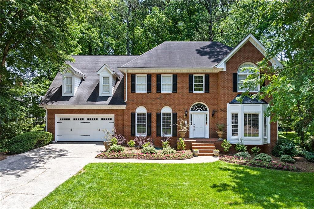 Luxury and timeless elegance define this exquisite all-brick estate nestled in the highly sought-after Old Paper Mill neighborhood. Set on over 0.43 acres of lush landscaped grounds, this home offers a rare and serene retreat. A tranquil stream meanders through the backyard, where a custom fire pit and tree-lined views create an inviting outdoor oasis—perfect for quiet mornings or lively evenings under the stars. Outdoor enthusiasts will love the proximity to Cochran Shoals Trail, just minutes away for walking, running, or biking along the Chattahoochee River.
Inside, the grand two-story foyer welcomes you with warmth and sophistication. Refinished hardwood floors flow throughout the main level, complemented by fresh paint and refined brushed bronze finishes. The kitchen, thoughtfully refreshed in recent years, features gleaming granite countertops, stainless steel appliances, and a bright, airy aesthetic centered around a cozy breakfast nook.
Formal living and dining rooms offer timeless spaces for entertaining, while a private library with custom built-ins provides a quiet escape. The expansive family room boasts rich wood-paneled walls, a stately fireplace, and seamless connection to the kitchen—ideal for gathering with loved ones.
Upstairs, the elegant primary suite is a true retreat, showcasing a vaulted tray ceiling and spa-like bath complete with a skylight, soaking tub, dual vanities, and shower. Three additional oversized bedrooms and two well-appointed baths provide plenty of space for family and guests.
The walk-out unfinished basement offers boundless potential—whether you envision a home gym, media room, or guest suite, it’s a perfect canvas for your dream expansion.
With charming curb appeal, mature trees, and a private, park-like setting, this home blends classic charm with thoughtful updates in a prestigious, established community. Come experience the lifestyle this special property has to offer. Schedule your private tour today!