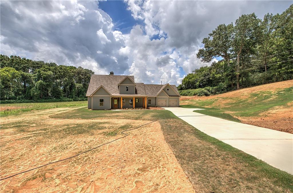 Welcome to your dream home nestled on a serene 2.55 acre lot with no HOA. This new construction ranch plan will be completed in just a few short weeks.
This 3-bedroom, 2.5-bathroom home offers modern convenience, timeless charm and excellent craftsmanship. Featuring an expansive front porch, an open-concept layout that connects the foyer, living, dining, and eat-in kitchen areas. The office area is a flex space that can be used as a 4th bedroom, playroom, gym or formal dining room. The kitchen boasts a spacious island, soft close cabinets and drawers, stone countertops, a pantry and modern SS appliances. The spacious primary suite and luxurious primary bathroom feature stylish fixtures and finishes with a tile shower and large walk-in closet. Other conveniences include a laundry room, LVP Flooring and carpet in bedrooms.