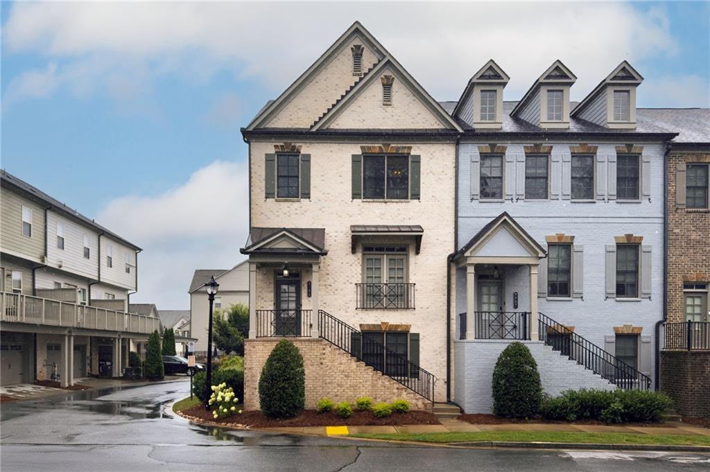 Welcome to this exceptional end-unit townhome in the sought-after Skyland Brookhaven community, showcasing the largest floor plan available and one of the most desirable locations in the neighborhood—privately nestled among green space and just moments from Dresden Village, PDK, and a vibrant array of shops and restaurants. Inside, soaring ceilings and gleaming hardwood floors create a warm, inviting atmosphere, while an open-concept layout seamlessly connects the living, dining, and kitchen areas for effortless everyday living and entertaining. The family room features a gas fireplace flanked by custom built-ins and is bathed in natural light from expansive windows. The chef’s kitchen is a standout, complete with a generous quartz island, walk-in pantry, and ample space for casual dining or morning coffee. A Juliet balcony off the dining area and a stylish powder room complete the main level. Upstairs, the spacious primary suite is a true retreat, offering vaulted tray ceilings, additional windows exclusive to end units, and a spa-inspired bath with dual vanities, a soaking tub, and a separate glass-enclosed shower. The expansive walk-in closet features custom-designed built-ins, maximizing both storage and organization. The terrace level includes a versatile bonus room with a full bath—ideal for a guest suite, home office, or second living area. A rare blend of space, light, and location, this home is a standout opportunity in Brookhaven.