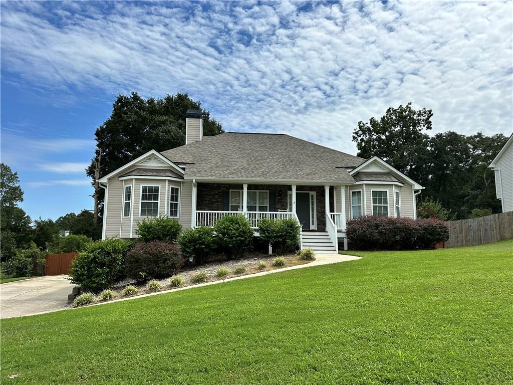 Large Raised Ranch home on a full basement with a three-car, drive-under garage. All the BIG items are updated. New HVAC system installed in 2022 and regularly serviced. New Roof in 2022. New flooring and interior paint completed in July 2025. Relaxing covered front porch. Maintenance-free exterior vinyl siding with stacked stone accents. Primary on Main with split bedroom plan. The partially finished basement has a den/office and a full bath, and plenty of room for storage & car parking. The home sits on a large .57 acre lot with new deck overlooking a fenced rear yard. There is so much room to grow your family and enjoy life! No HOA to pester you. This is the one! Recently vacated & ready for move-in.