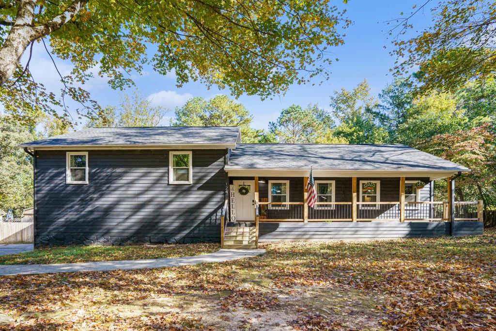 Fully Renovated Home with Modern Charm and Incredible Outdoor Living! Completely Reimagined from Top to Bottom, this stunning 4-Bedroom, 2-Bath Home blends Modern Design, Cozy Character, and Versatile Living Spaces. Set on a Flat, Fenced Lot surrounded by Mature Trees, it's the perfect retreat with easy access to Shopping, Dining, and Lake Allatoona Recreation. Step inside to a Bright, Open Main Living Area featuring Luxury Flooring, Fresh Paint, and Designer Touches Throughout. The Stone Fireplace creates a warm focal point for the Cozy Front Sitting Room, while a Second Statement Fireplace anchors the Spacious Family Room, ideal for gathering and entertaining. The Renovated Kitchen shines with White Shaker Cabinetry, Quartz Countertops, Custom Backsplash, and Premium Stainless-Steel Appliances, offering seamless flow to both Dining and Living Areas. Upstairs, the Primary Suite feels like a true escape with a Fireplace of Its Own, a stylish Accent Wall, and a Spa-Inspired Ensuite Bath boasting a Walk-In Shower with Herringbone Tile and Sleek Black Fixtures. Two Additional Bedrooms share a Hall Full Bathroom on this level which offer comfort and flexibility for Guests or a Home Office. The Fully Finished Lower Level expands your living options with a Fourth Bedroom, Media or Game Room, and plenty of space for a Home Gym, Playroom, or Studio   perfect for modern lifestyles that demand flexibility. Outside, enjoy your Wraparound Front Porch, Spacious Back Deck with Pergola, and Large Fenced Backyard ready for entertaining, gardening, or play. All this in a Prime Woodstock Location, just minutes to Downtown Woodstock, Lake Allatoona, Red Top Mountain State Park, and Sought-After Cherokee County Schools. Whether you're Cozying Up by One of the Fireplaces or Hosting Summer Evenings Under the Stars, 124 Dockside Downs offers a lifestyle as Stylish as It Is Comfortable.