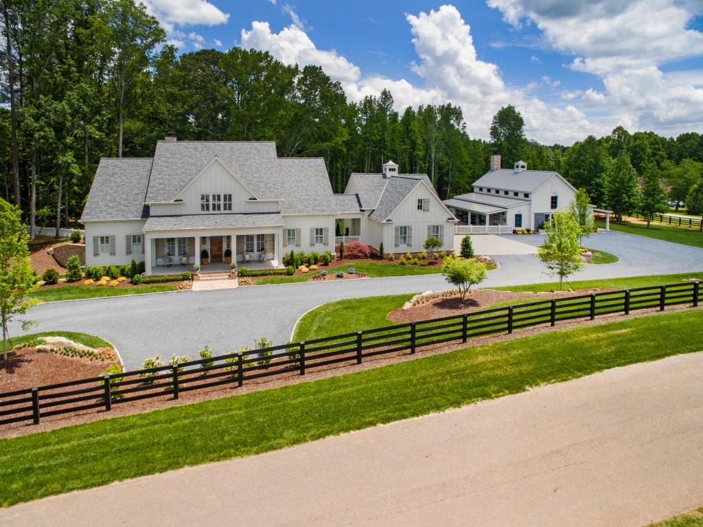 Smith & Kennedy custom built modern farmhouse nestled on 5.7 acres with one of a kind party barn. Open floor plan features master on main with private screened-in sleeping porch, his and her office, formal dining room, sitting room opening to cozy family room, stunning kitchen with top of the line Thermador appliances and a full working butlers pantry. 3 bedrooms upstairs with 3 full baths. Expansive outdoor living area with fireplace, both living and dining areas overlooking lush backyard ready for a pool. Unimaginable party barn ideal for entertaining large groups features full chef's kitchen, 2 bedrooms with full bath, workout room & craft room. Full unfinished basement awaiting your finishes!