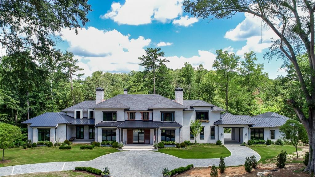 2019 Atlanta Homes and Lifestyles Show House.  Extraordinary custom level construction on historic High Water estate.  5.2 acres overlooking your private lake. Designed by architecture firm Logan Design Group and built by Southern Gentry Homes. Transitional style design with painted brick, natural stone, slate, iron, natural wood, and other natural metals. Amazing light, huge roof overhangs, and a spectacular main level master suite.