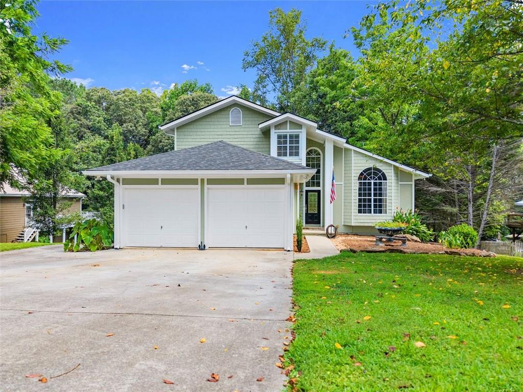 Stunning home in Dawsonville, that backs up to a large Lake Lanier Corps of Engineers peninsula with lake views and exceptional privacy. As you enter, you’re welcomed by an open layout filled with natural light, true hardwood floors, and an oversized dining room that seats 12+ people. The spacious kitchen features granite countertops, an island, and great views of the private backyard and Corps land. The cozy living room includes a fireplace, creating the perfect space for gathering and relaxing. The main level also offers a guest bedroom and half bath, ideal for visitors or extended family. Upstairs, the large master suite includes a double-sided fireplace, a spacious bathroom, and serene views. An additional bedroom and full bath are also located on the upper level. The fully finished terrace level is perfect for multi-generational living or potential rental income. It features two bedrooms, a full bath, a full kitchen, a living room with fireplace, and a separate driveway and private entry. Beautiful landscaping, open living spaces, and direct access to Corps land make this a rare and versatile property you won’t want to miss. Conveniently located just minutes from War Hill Park, public boat ramps, HWY 400, and North Georgia Premium Outlets. Schedule your showing today!