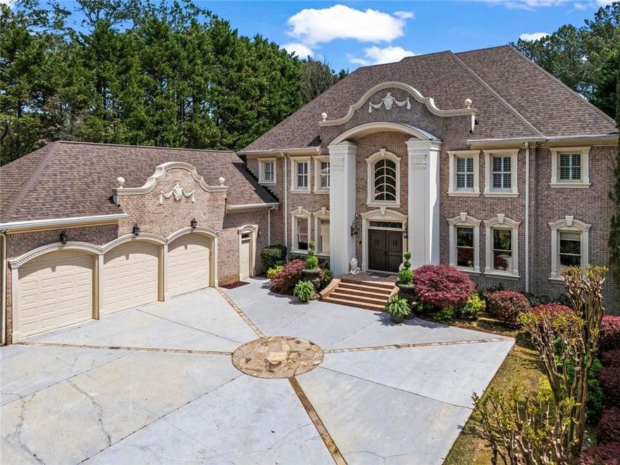 Spectacular brick custom built estate located on the Golf Club Of Georgia “Lakeside”, In Gated Northshore of Windward.  The grand entry will “take your breath away!”  with a curved staircase and stunning shimmering chandelier.  Enchanting living areas radiates elegance and thoughtful craftmanship throughout this custom-built home with hardwood flooring and extensive crown molding.  Step right out from the main living area to your own private resort with swimming pool, spa & waterfall surrounded by a stone patio and private lawn plus access to a full bathroom.  The two -story formal living, banquet size dining rooms and paneled study boasts beautiful chandeliers.  The charming family room features a stone two- sided fireplace and opens to a chef’s granite gourmet kitchen—one of three full kitchens, including a second prep kitchen nearby and a full kitchen on the terrace level, ideal for entertaining on every scale. Separate eating area leads to a cozy sun room overlooking the fabulous outdoor stone patio and beautiful swimming pool.  The owners retreat on the main level enjoys a custom fireplace, built-in cabinetry and has views of the waterfall pool and private back yard.  Luxurious bathroom with double vanities, water closet with bidet and walk in closet plus private access to the paneled study.  Four spacious additional bedrooms on the second level enjoy private baths and custom walk in closets  and separate back staircase.  An entertainer’s dream and/or second home on the terrace level with a full double island granite kitchen, home theater, mirrored exercise room, steam shower, sauna, guest suite with private bath and travertine flooring.   This home delivers unparalleled luxury and lifestyle in one of Alpharetta’s most desirable gated communities.  The Northshore of Windward has it’s own clubhouse, sport court, swimming pool and tennis courts.  
Windward is a 3,400 acre master planned community that enjoys an award winning environment that has been designed to take full advantage of the private 195 acre Lake Windward.  A private membership at Windward Lake Club, with tennis center, pools and marina available. Enjoy fishing, canoeing and sailing on this peaceful setting.  This community surrounds The Golf Club of Georgia, a private membership club with two 18-hole championship courses. Extra Details: two laundry rooms, three kitchens, irrigation system and wired for the future.