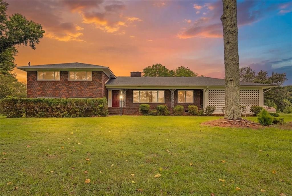 Brick facade residence with a prominent red entry door