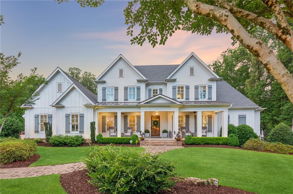 Magnificent custom built farmhouse by Smith & Kennedy, located in the exclusive Farms at Trinity enclave. Set on a sprawling fully gated and fenced 4-acre lot, this home is an all encompassing retreat like no other. A Brand new custom Douglas Fir Post and Beam Barndominium was just constructed on the property in addition to the main residence along with a new oversized garage with front and rear garage doors and a new impressive pavilion with an incredible outdoor chef's kitchen that overlooks a heated Pebble Tec Saltwater pool!  The main home features 5 bedrooms, 5 full bathrooms, and two half bathrooms. The airy, open layout showcases a lavish primary suite on the main level, complete with a serene bathroom featuring a frameless glass shower, freestanding tub, generous walk-in closet, and a charming screened porch. The state-of-the-art kitchen boasts high-end Thermador appliances, twin refrigerators, sleek quartz surfaces, a spacious island, a secondary prep area, and a mudroom with built-in workspace and side entrance. A soaring breakfast area opens to an inviting great room with a fireplace, rustic beams, and striking metal-framed doors. A sophisticated dining room and versatile study round out the main floor. The upper level offers 3 private ensuite bedrooms, a cozy loft/media space, hardwood flooring, and additional storage. The expertly finished lower level includes a guest suite with bath, a recreation area with wet bar, a game room, fitness space, and ample storage. Step out into your secluded, level backyard featuring your own piece of paradise.  The Barndominium features a full guest house with high end custom finishes throughout. It also boasts a full work shop, office with loft space, and a huge recreational space perfect for any hobbyist or athlete. And bonus--The barndominium has a commercial and residential certificate from Cherokee county! The new outdoor pavilion features a half bathroom and an outdoor shower. The fully equipped outdoor kitchen features an IL Ferno wood fired pizza oven and all stainless steel Twin Eagle Appliances, infrared heaters, custom pavers, and a Sonos Sound system. The new garage, making this the FOURTH garage space on the property, features a front and rear garage door, EV charging capabilities, and custom flooring and lighting and the garage is heated and cooled! Other features include a whole house generator, full irrigation at all landscaped areas, new driveways with slate chips and lined with granite carbing for ample parking, and beautiful seasonal flower beds. All furnishings are negotiable! Move right in and embrace luxurious estate living. Sought after Creekview school district! Unbeatable location in the heart of it all--Close to Milton/Alpharetta, Ball Ground, and Canton. Lower Cherokee Taxes!