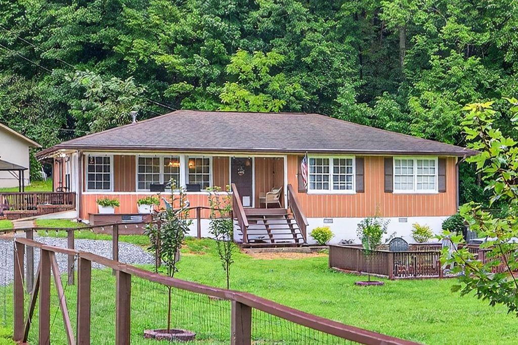 Welcome to 8 Taylor Rd, located in the heart of the picturesque town of Helen, GA. This beautifully updated home is perfect for those looking for a move-in ready property in a unique and charming location. The Chattahoochee river and parks are located just across the street. The amazing yard is fenced, landscaped and has two sheds for storage or hobbies. As you step inside this home, you'll immediately notice the tasteful updates that have been made to this home. The remodeled countertops, new fixtures, blinds, outlets, and chandelier create a modern and stylish feel throughout the home. The entire interior has been freshly repainted, giving the home a bright and welcoming ambiance. The town of Helen is known for its quaint German-themed architecture, making it a popular destination for tourists. This property is perfectly located to take advantage of all the town has to offer, with restaurants, shops, and activities just a short walk away. This property is a rare opportunity to own a move-in ready home in a prime location. Don't miss your chance to experience the unique charm of Helen, GA in this beautifully updated home. PERFECT for a great vacation home or potential short term rental.
