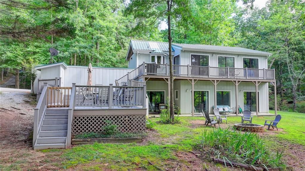 23K Price Improvement! FULLY FURNISHED LAKEFRONT RETREAT - BOAT & TRAILER INCLUDED! Dreaming of your own slice of lakeside paradise? This beautifully updated, turnkey lake house comes fully furnished including a 1997 Larson 21-ft speedboat with trailer, inboard V-8 motor (recent long block replacement), and freshly reupholstered interior. Nestled in a peaceful setting, this home offers more than just a view it's a lifestyle. Inside, enjoy a bright, modern kitchen with sleek new stainless-steel appliances and a high-end hood venting outdoors. The primary bathroom has been completely renovated with a luxury tiled shower, sliding glass doors, updated lighting, and a new vanity. All bathrooms feature brand-new toilets, combining comfort with contemporary design. Step outside to find lake-friendly upgrades: a covered carport for your boat or car, a roof over the boat slip, a brand-new dock gangway, and a cozy fire pit in the backyard perfect for evening gatherings. Tree removal has opened up stunning lake views, enhancing the natural beauty around you. Enjoy the convenience of a shared dock the last covered slip on the left is yours, and shared maintenance means costs are divided among just eight owners. Whether you're looking for a peaceful getaway or a lucrative short-term rental, this fully loaded lakefront home is move-in ready. Answer the call of the lake today.
1 Year home warranty included.