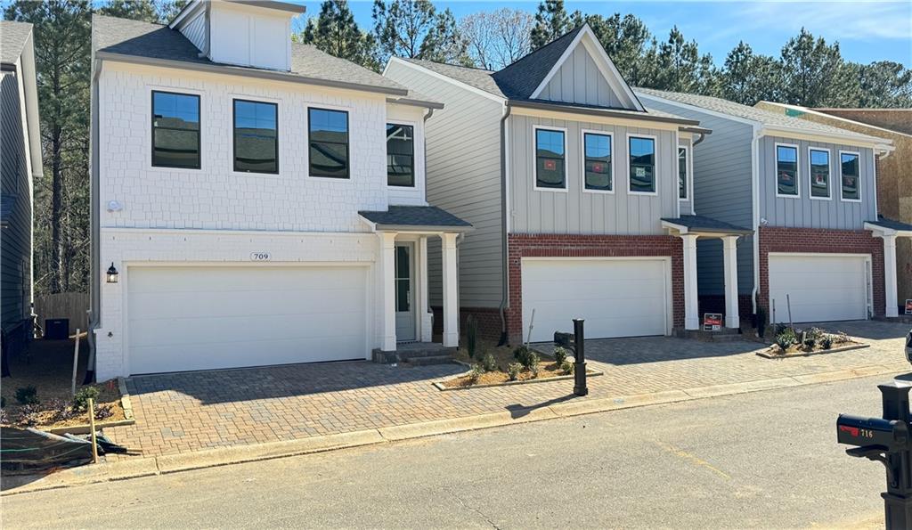 Walking distance to the Highly Acclaimed Downtown Woodstock area. Fenced-in backyard for ultimate privacy ~ Step into this gorgeous home with a welcoming entrance foyer leading to a wrap-around staircase. Around the corner, you have a top-of-the-line kitchen with 42" soft-close gray cabinets, a beautiful chimney vent hood, quartz countertops, and an island with barstool seating overlooking the fireside family room. The family room features an electric, mood-setting fireplace framed by a floor-to-ceiling shiplap wall. The main floor also features a spacious, open-concept dining area and powder bathroom. Walk upstairs to the light-filled bedrooms and laundry room with a washer and dryer. The master bedroom is spacious, featuring a gorgeous en-suite bathroom with a double vanity and quartz countertops, as well as a large walk-in closet. Located just outside the master bedroom is the convenient laundry room, and down the hall, you have 2 guest bedrooms with a shared bathroom with a double vanity. Explore this amazing community featuring a Luxurious Clubhouse with amenities including a poker table, pool table, catering kitchen, Fitness center, Swimming pool w/cabana, Pickleball, Bocce ball, Fire pit, and Dog park, all within this gated community. You are just 1 short mile from Historic, Downtown Woodstock, rated as one of the top entertainment districts in Suburban Atlanta. Walk to lively downtown Woodstock, with restaurants, shops, nature trails, parks, art, and music venues with planned events for the entire family. To top off this fantastic home, for the outdoor enthusiast, you are only 1 mile away from Rope Mill Park with miles of hiking and biking trails and a river for kayaking and fishing. Don't miss this opportunity to make this home yours. Schools are Woodstock High, Middle, and Elementary. Rental Criteria: Income 3x the rent (roughly $9k per month), Excellent Rental History, and no late credit on your credit report in the last 2 years. Tenant occupied. Home will be ready September 5th.