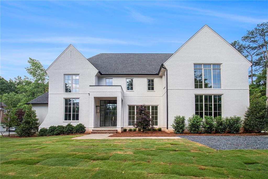 Set on a sprawling 1-acre lot in an established, tree-lined neighborhood near Dunwoody Country Club, this stunning 5-bedroom, 5.5-bathroom custom Jim Hogan home, set for Spring 2025 completion, is a masterclass in timeless design and contemporary comfort. Thoughtfully curated by Jim Hogan & A.Wooten Interiors, every detail has been meticulously selected to create an atmosphere of refined sophistication. Step inside to a grand foyer leading into the heart of the home—an open-concept kitchen and family room designed for seamless living and entertaining. The gourmet kitchen features marble countertops, unlacquered brass faucets, custom cabinetry, and top-tier appliances, blending both beauty and functionality. The space flows effortlessly into the sun-drenched family room, where a statement fireplace sets an inviting tone, while large sliding doors open onto a covered porch, perfect for year-round entertaining and al fresco dining. The primary suite is a private retreat, boasting a spa-inspired ensuite with quartz countertops, dual vanities, a soaking tub, a walk-in shower, and luxurious unlacquered brass fixtures, with two expansive walk-in closets providing ample storage. Four additional ensuite bedrooms ensure comfort and privacy for family and guests. Additional highlights include a three-car garage with ample storage, an expansive lot with endless potential for a pool, garden, or outdoor entertaining space, designer lighting throughout by Visual Comfort, and quartz countertops in the laundry and primary bath for durability and elegance. Located just minutes from top-rated schools, premier shopping, fine dining, and world-class golf, this is a rare opportunity to own a custom-built masterpiece in one of Dunwoody’s most coveted locations. Don’t miss your chance to make this exceptional home yours—schedule a private tour today!