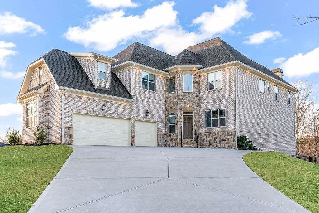 Exquisite Luxury Estate in Prestigious Champions Park where elegance, comfort and sophistication converge in this magnificent 6-bedroom, 5-bathroom estate. Nestled on a coveted corner lot, this home features a fully finished basement and an array of upscale amenities tailored for refined living. Experience the interior elegance as you step through the grand two-story foyer onto timeless hardwood floors that guide you through the main level's open, sunlit spaces. A formal living room for entertainment, while the luxury dining room—enhanced by a custom accent wall that adds style to every gathering. The gourmet kitchen is a culinary dream, featuring sleek white cabinetry, oversized center island with built-in microwave, gas cooktop, wall oven, and high-end appliances next to the spacious breakfast area with views of the family room. Enjoy seamless indoor-outdoor living with access to a walkout patio and fenced backyard perfect for relaxing or entertaining. A main-level guest bedroom with a full bath offers privacy and ease for visitors or multi-generational living offering both comfort and functionality. Upstairs, the expansive primary suite includes a serene sitting area, spa-inspired ensuite with soaking tub and separate shower and custom-designed walk-in closets. Three additional bedrooms and two full baths complete the upper level; each thoughtfully designed with ample space and storage. The fully finished terrace level serves as a private guest or in-law suite, featuring a bedroom and full bath, kitchen, dining area and large family room with direct walk-out access to the immaculately landscaped fenced backyard. Spacious three-car garage with storage and dedicated EV charging outlet. This unbeatable location is just minutes to Camp Creek Marketplace, dining, shopping, Hartsfield-Jackson Atlanta International Airport, I-285 and major expressways, Woodward Academy and Atlanta’s vibrant Intown district. This home blends prestige and convenience into one of South Fulton's most exclusive communities. Priced below market value, this is truly a "Must-See" Sunday 8/3 - 2-4PM. Showings begin Friday 8/1.