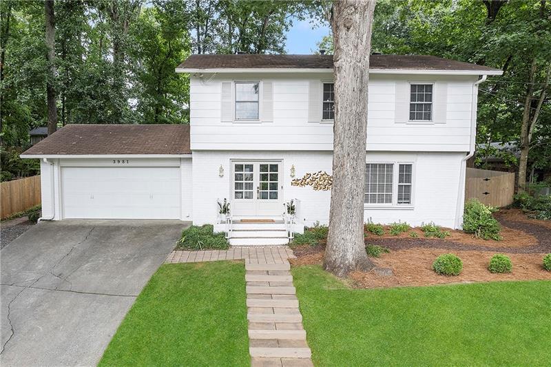 Brick Traditional in Huntley Hills! Progressive vibes meet casual elegance in Chamblee with one of the only few traditional floorplans in the neighborhood! One of the most exquisitely updated homes in sought-after Huntley Hills with surely one of the most desirable lots and locations. Picturesque front elevation with lovely French beveled glass front doors off the brick porch. Naturally flowing floorplan and bespoke design mingle beautifully to craft the city home you have been dreaming of! The openness with dedicated spaces pair to make this property ideal both for entertaining as well as everyday living. This four bedroom, two full and one partial bathroom residence exudes an open, airy feel with an abundance of natural light flooding through the blinds and striking architectural details! The main level showcases a custom embellished foyer and two-story stairwell, bright living room, dedicated dining room with picture-frame molding, and the luxurious kitchen. This breathtaking kitchen sparkles with soft-close escada cabinetry, quartz counters, intricate fan-detail backsplash, and stainless-steel appliances. Take the opportunity to dine in your eating room with views of the far stretching, private oasis awaiting beyond its double sliding glass doors, or choose to dine alfresco on your covered patio or cabana. Enjoy walking upstairs to your primary oasis as you climb alongside the custom feature walls and handcrafted white oak and metal railings. The oversized primary suite, beautifully appointed with a custom feature wall, offers double closets, wiring for mounted tv, updated ensuite, and overlooks the gorgeous backyard. Also upstairs, you will discover three more generous secondary bedrooms with ample storage space and another full bathroom with the most stunning sconces. While indoors, you will appreciate the many designer upgrades and finishes, stunning Progressive Lighting and Kohler fixtures, custom rails, and hardwoods throughout. The two-car garage on kitchen level, with its brand-new garage door and system, and private backyard access, provides all the storage and ease one can desire. The backyard is truly a showstopping treat! Designed by a local landscape architect, this wonderment boasts a covered patio, covered cabana with Trex decking, and slate chip permeable paved courtyard with fire pit. Rock and timber planter walls with built-in floating benches terrace to the verdant sodded lawn and playset. Already prepared for an outdoor television on the patio, this secluded backyard with privacy fence is ideal for a peaceful retreat, entertaining, active play, and throwing the ball to a pup or two. Located right around the corner from the Huntley Hills Swim and Tennis Club. Proximity to local shopping, dining, neighborhood park, schools, trails, and all Downtown Chamblee has to offer! This genuinely impressive property will surpass all your expectations. Welcome home to 3981 Longview Drive! *Photos are virtually staged with an example of tree removal, with furniture and decor.*