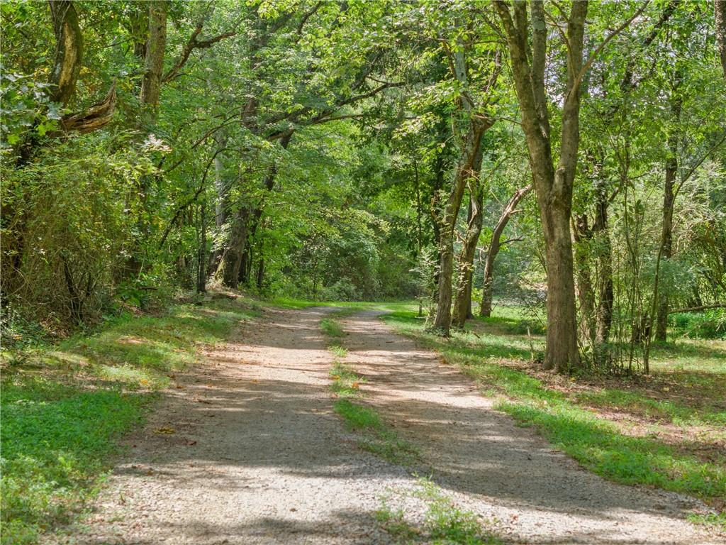 Don't miss this incredible opportunity in beautiful Clermont, Georgia! Over 5 serene and relatively flat acres await your vision—whether you're looking to develop, subdivide, or remodel for long-term investment. The property features both a single wide and a double wide mobile home, each with renovation potential. The double wide includes 3 bedrooms and 2 full baths, offering a solid foundation for a flip, rental, or personal residence with some TLC.
Situated on a private well, but with county water available at the road, giving you flexibility in utility planning. With over 320 feet of road frontage on Campground Road, access and visibility are ideal. One of the biggest advantages? This parcel is located in the highly sought-after school district of Wauka Mountain Elementary, North Hall Middle, and North Hall High School. Don’t miss this opportunity in a fast-growing area!