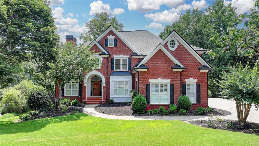 Picture-perfect 6 bed/5 bath CUL-DE-SAC home with GUEST BEDROOM and FULL BATHROOM on the main, professionally FINISHED TERRACE LEVEL and tons of UPDATES! 5 YEAR OLD ROOF, 3 REMODELED BATHROOMS, 3 YEAR OLD WATER HEATERS and FRESHLY PAINTED EXTERIOR. Step through the arched front porch and into the 2 story hardwood foyer. To your right is the family-sized DINING ROOM with picture frame and crown molding, plantation shutters and hardwood floor. To your left is an elegant OFFICE/MUSIC/SITTING ROOM with gorgeous vaulted ceiling, plantation shutters and hardwood floor. The soaring two-story family room features a stacked stone fireplace, custom built-ins and a breathtaking wall of arched windows that frames picturesque views of the wooded backyard. The beautifully appointed kitchen features custom cabinetry, granite countertops, stainless steel appliances, double ovens, gas cooktop, tile backsplash, a large bar counter, hardwood floor and walk-in pantry. The light, bright bayed BREAKFAST ROOM has French doors that lead out onto the stunning SUNROOM featuring an absolutely gorgeous new tongue and groove wood plank ceiling, slate tile floor, expansive wall of windows with high-end molding and views of the tranquil backyard! A second door from the breakfast room opens up to the huge cedar deck, Perfect for entertaining! A sought-after MAIN FLOOR GUEST BEDROOM with full bathroom with custom cabinetry and tile floor and shower. The updated LAUNDRY/MUDROOM features custom cabinetry and a convenient sink. Double staircases lead to the second level. The luxurious MASTER SUITE features a tray ceiling and a beautiful bayed SITTING AREA with vaulted ceiling—ideal for a quiet reading nook or morning coffee retreat. The COMPLETELY UPDATED master bathroom is a spa-like retreat with custom cabinetry, frameless glass shower with modern tilework, stand-alone tub, double vanity and HIS-AND-HERS WALK-IN CLOSETS with custom cabinetry. THREE additional spacious secondary bedrooms include one with a beautifully updated en-suite bath, while the other two bedrooms share a renovated Jack and Jill bathroom with custom cabinetry, double vanity and tile floor and shower. The professionally finished TERRACE LEVEL has space for everyone and features an expansive family room with custom built-ins, a large tiled GAME ROOM/DINING AREA with tray ceiling, a WET BAR with stain-grade cabinetry, dishwasher and granite countertops. An additional flex room/exercise room and large bedroom and full, tiled bathroom complete this spacious area. Step out onto the COVERED PATIO and enjoy the private, wooded backyard and stone WATER FEATURE. Situated in Forsyth County’s most prestigious GATED/GOLF/SWIM/TENNIS/PICKLEBALL community in the sought-after LAMBERT HIGH SCHOOL district! This wonderful community features 24-HOUR SECURITY, a PRIVATE JACK NICKLAUS GOLF COURSE, clubhouse with fitness center, PICKLEBALL, TENNIS courts and tennis teams, swimming POOL with kid’s pool and waterslide, swim team, playground area and so much more! Welcome home...